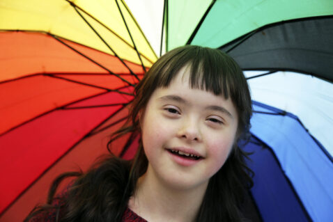 Portrait of little girl smiling on background of the umbrella NDIS Service Provider Melton & Ballarat Area